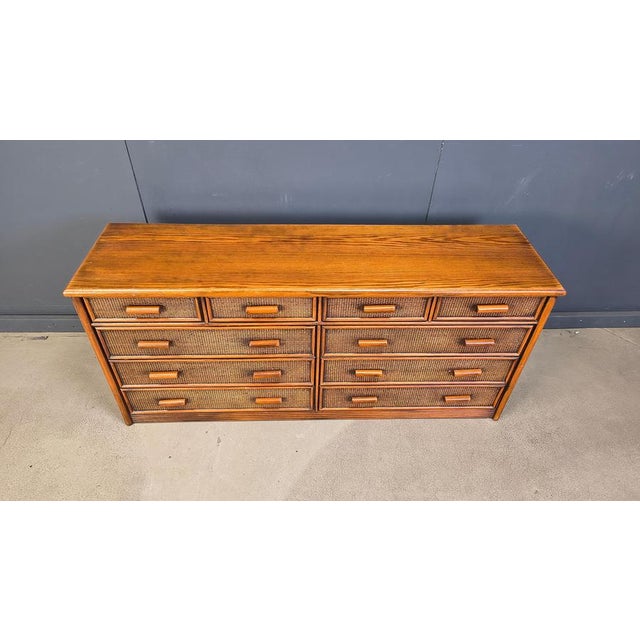 Elegant wooden and rattan chest of drawers with 8 drawers. This dresser offers a lot of storage space and is in very good...