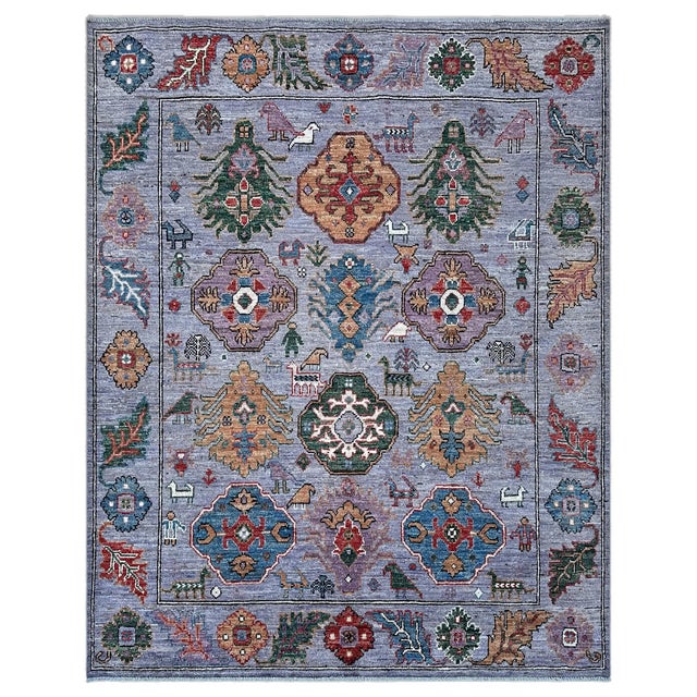 A rare lavender Oushak rug where cusped medallions and feathered tree forms share the field with a woven menagerie of...