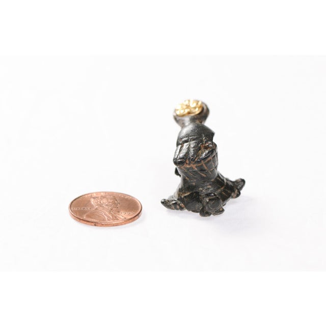 A unique bronze artifact from the Ancient Roman Empire, fashioned into a pendant trimmed with 21 karat gold bail accent....