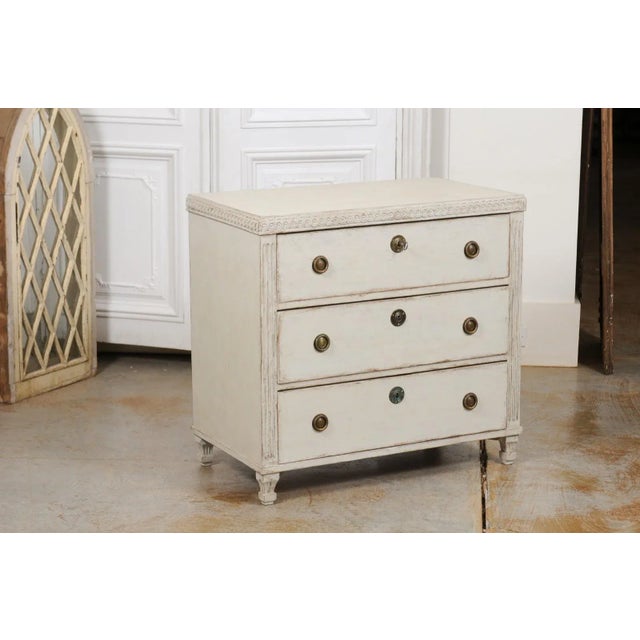 A Swedish neoclassical style painted wood chest of drawers from the mid-19th century, with guilloche motifs and fluted...