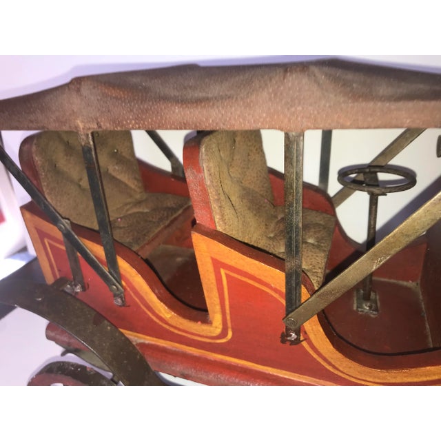 An old wooden Model T toy car. Very attractive and will look great to anchor a bookshelf or vignette to add warmth and...