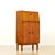 This fabulous mid century bar cabinet was made in England during the 1960s. Produced in teak, the top cabinet doors open...