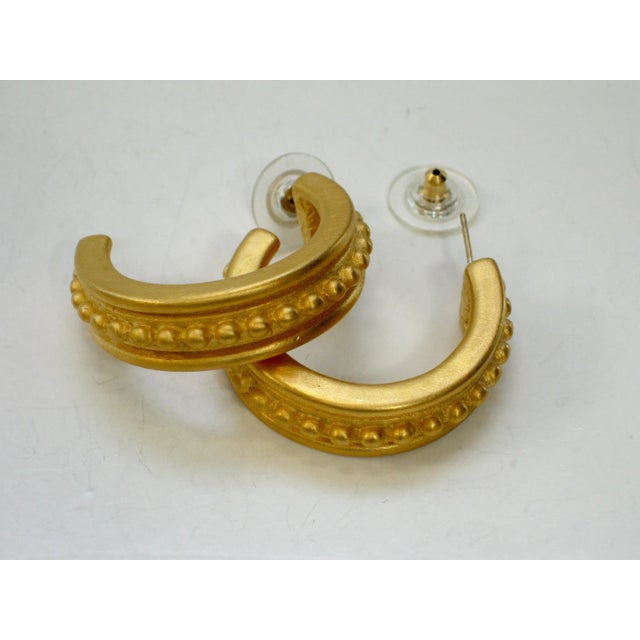 1980's Givenchy matte gold ribbed 3/4 hooped post back earrings. Signed: "Givenchy, Paris, New York". I have been...