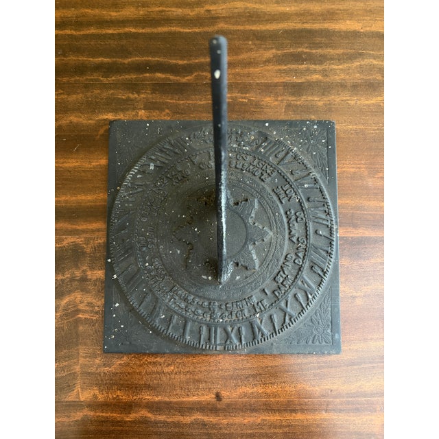 A stunning vintage iron garden sundial featuring a horse and a poem reading, "Serene I stand among the flowers and only...