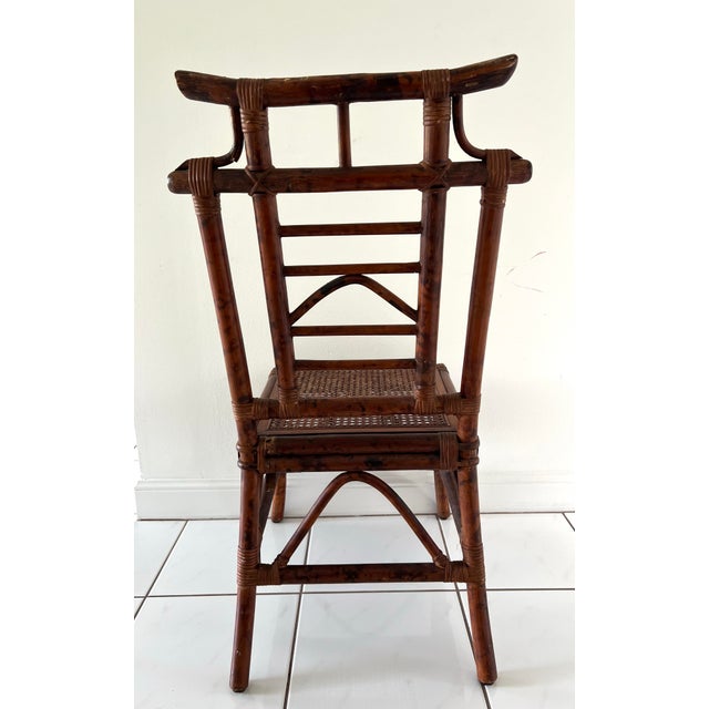 Vintage burnt bamboo accent chair with pagoda design and cane seating. Seat measures 17" x 17"