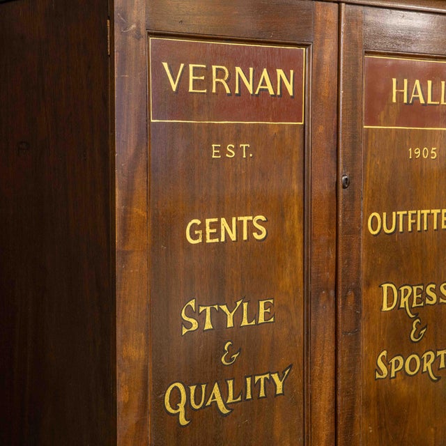 A super Edwardian mahogany single piece cupboard with later sign writing but very likely in keeping with it's original use...