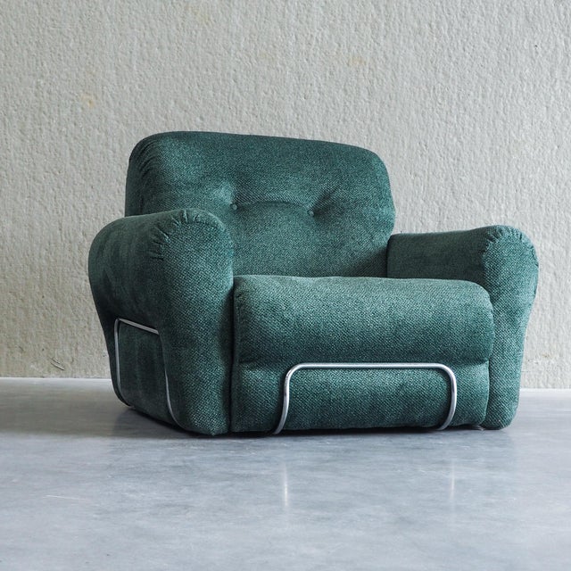 This mid-century armchair from Italy features a distinctive combination of soft, textured upholstery and a sleek metal...