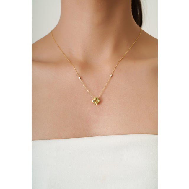This elegant station necklace features a 2.04 carat natural lemon topaz set in 14K yellow gold. The lemon topaz measuring...