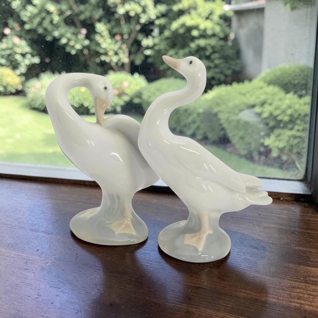 A companion pair of Lladro porcelain Little Duck figurines, models #4552 and #4553, designed by Fulgencio García and...