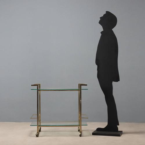 Trolley with double shelf and bottle holder, brass-plated metal and clear glass. This piece is attributed to the mentioned...