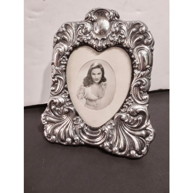 Sterling silver frame with a heart window, Antique circa 1900. Edwardian Beaux-Arts design. Swirling pattern with a...