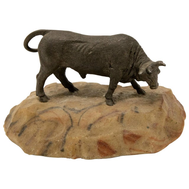 Offering this sculpture of a bronze bull on stone base. Starting with the base is a sand colored stone with some...