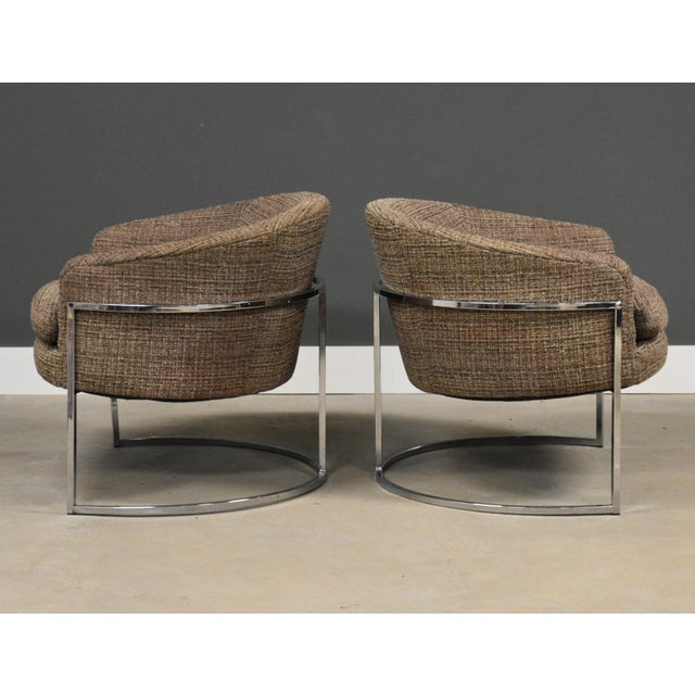 A pair of mid century modern brown chrome barrel back lounge chairs in the style of Milo Baughman. Tweed fabric in very...