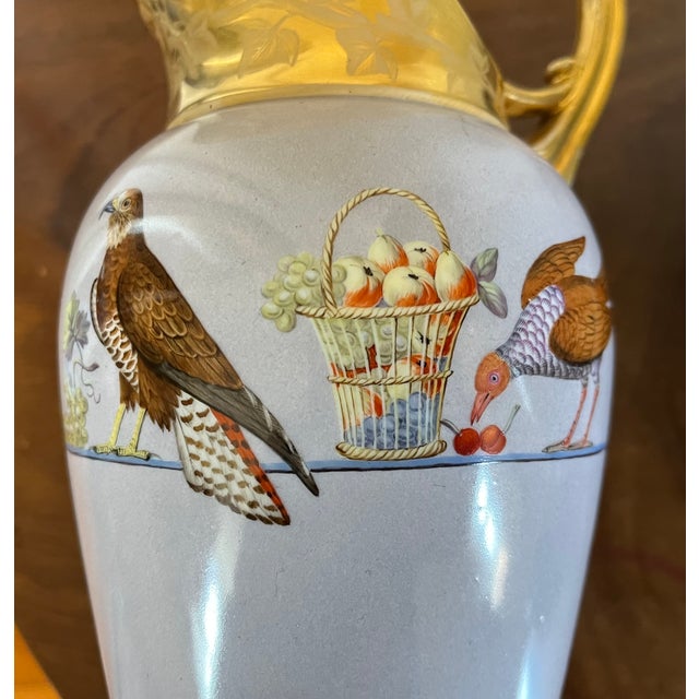 Antique 19th century Paris porcelain neoclassical tall pitcher decorated with exotic birds and a fruit basket. Light blue...