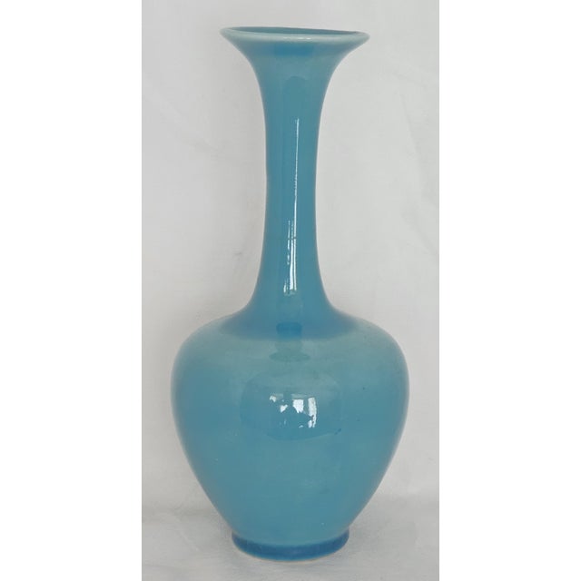 A beautifully crafted Rookwood Art Pottery Vase, shape 778, finished in a rich blue high‑gloss glaze and marked on the...