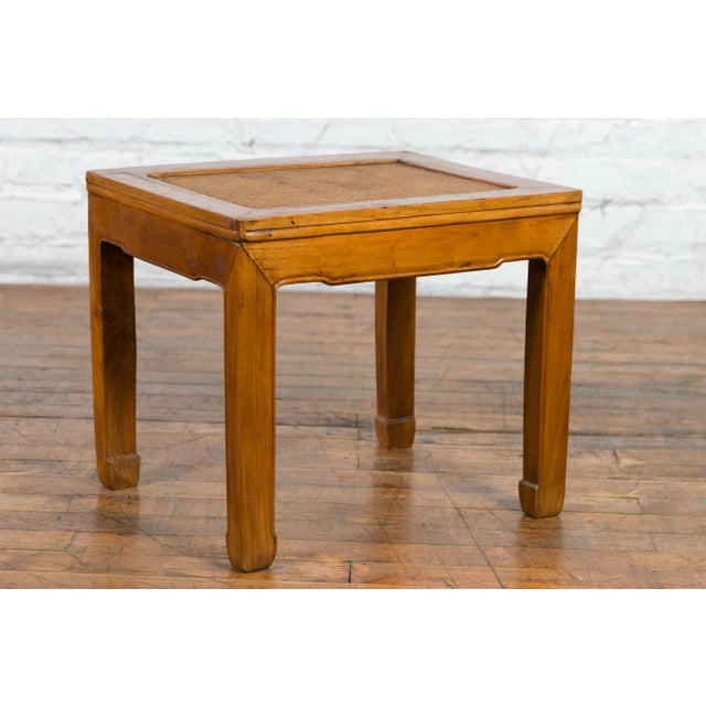 A Chinese late qing dynasty period side table from the early 20th century, with natural finish, woven rattan inset and...