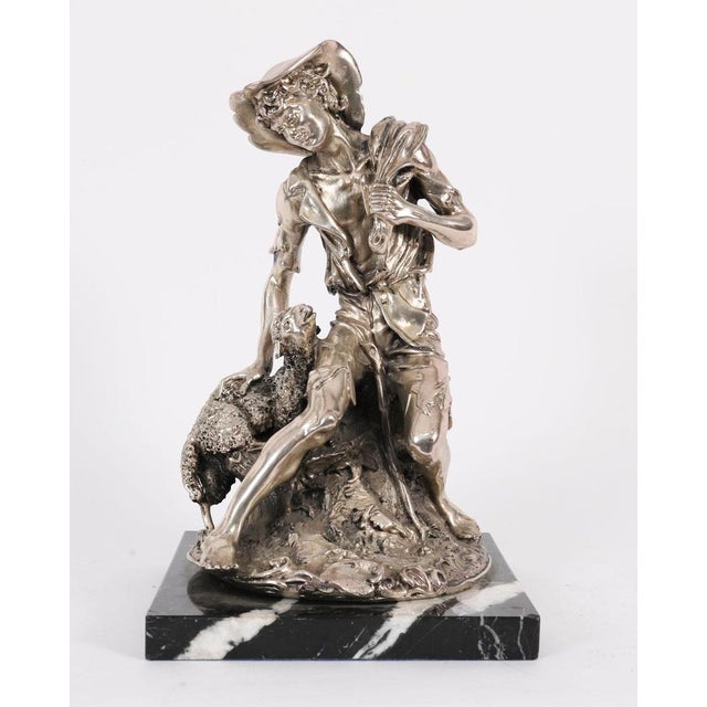A lovely italian silver-plated bronze sculpture of a shepherd boy and a lamb mounted on a polished marble plinth, circa...