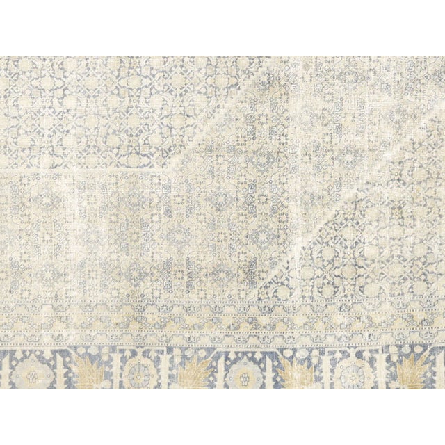 This lavish hand-knotted Persian Tabriz rug adds the perfect touch of elegance to any space. Its intricate design features...