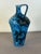 Jug-shaped vase in majolica and glazed terracotta with abstract polychrome red and black motifs on a blue background,...