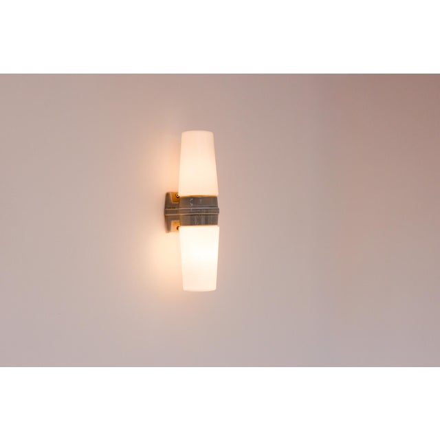 A desirable mid-century modern double porcelain wall sconce for bathroom use, produced by ifö, sweden, in the 1950s. This...