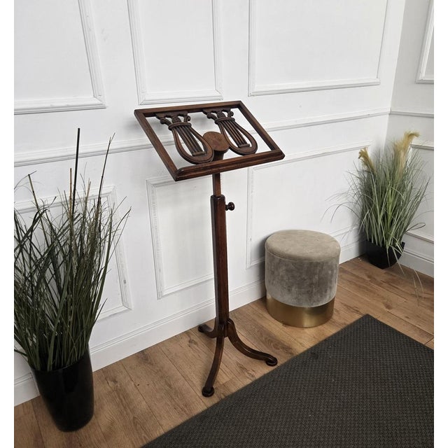 Beautiful tall floor lectern book stand with adjustable height and two carved lyre shapes standing on triod feet.