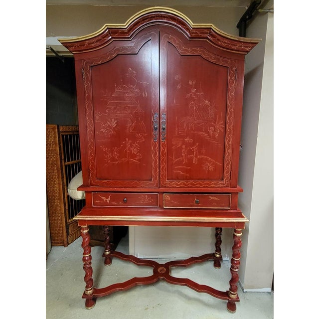 Red chinoiserie cabinet in a traditional English style with Asian scenes and gold accents. Very versatile, it can be used...