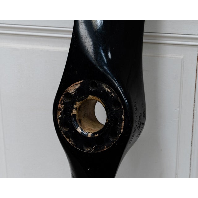 Vintage EVRA aircraft propeller from the 1960s, crafted from wood with metal components. Its black finish, original...