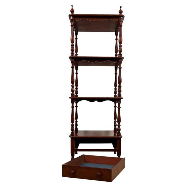 An elegant 19th-century English display cabinet, finely crafted from mahogany and distinguished by its unusually slender...
