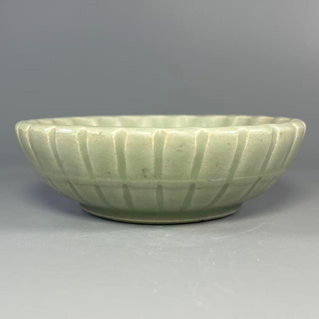 This shallow‑form bowl is made of authentic Longquan Celadon. It features classic celadon‑green glaze with evenly‑spaced...