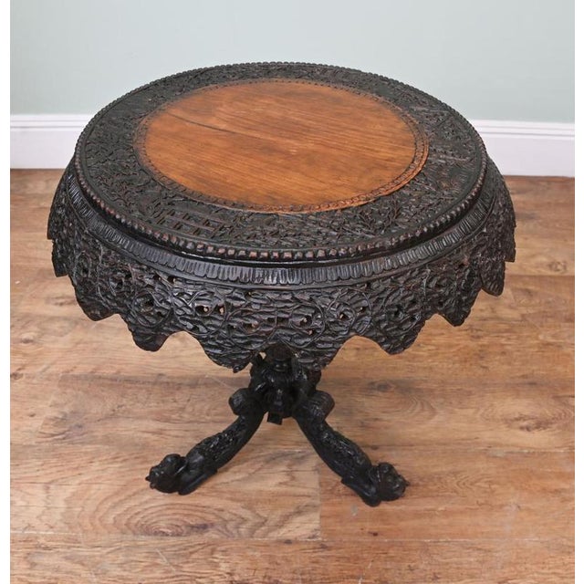 Fine quality carved Burmese tip table with a finely carved top and base The carving is very ornate as is typical with...