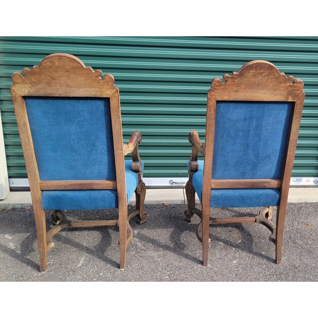 Antique ca 1900 pair of French gothic style arm or throne chairs. Featuring fluer de lis carved crest top, ornate shell...