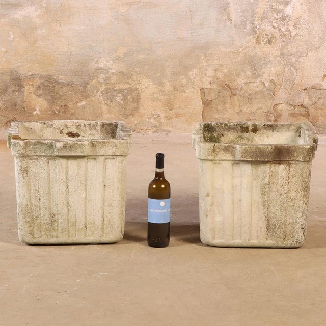 These square ribbed planters in the manner of WIlly Guhl stand approximately 14 inches tall and has a simple, sturdy form....