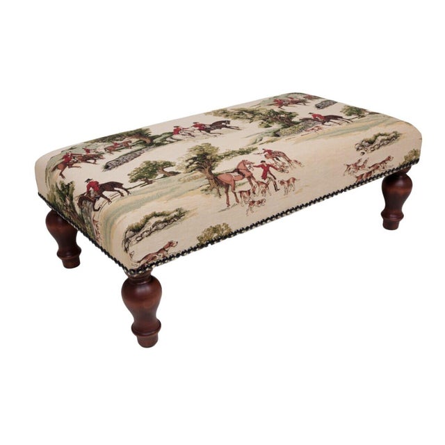 Meticulously handcrafted in the United Kingdom, this upholstered stool boasts classic studding and hand-polished solid...