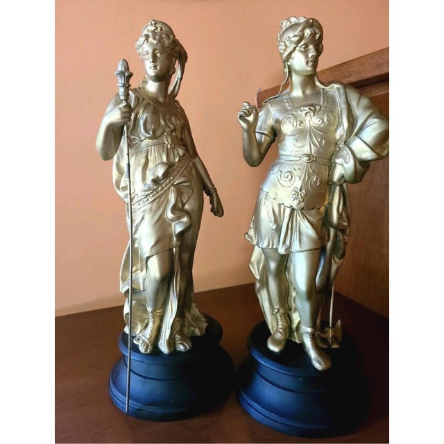 This antique pair of French 19th century gilded spelter sculptures represent the Roman gods Mars, god of war depicted in...