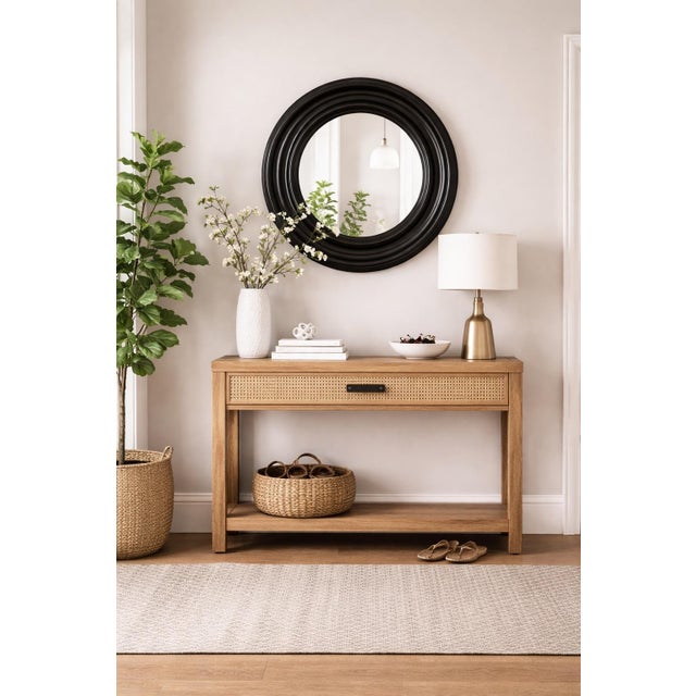 Striking and sculptural, this vintage round wall mirror features a deep concentric frame in a rich black finish, offering...
