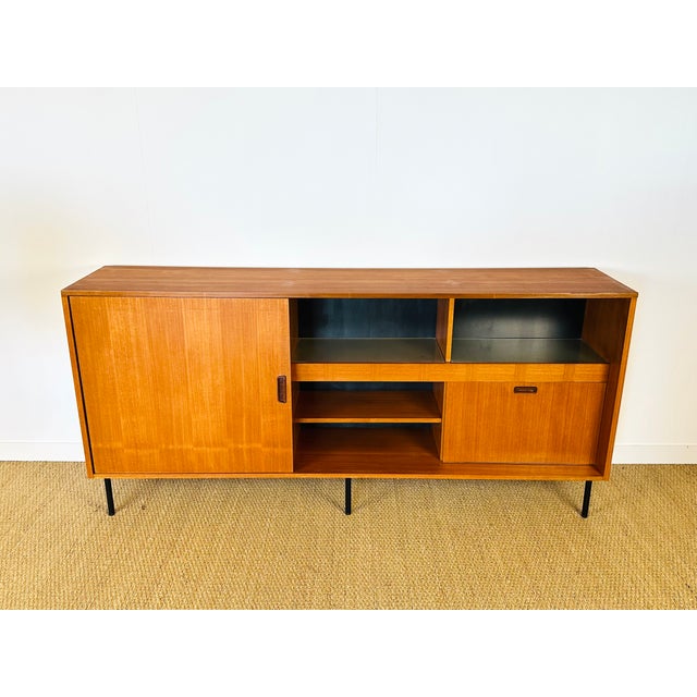 Vintage Scandinavian teak sideboard dating from the 1960s. Features a sliding door, a hinged door, and ample storage....
