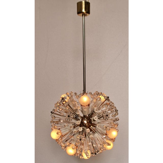 This ceiling lamp was designed by Emil Stejnar in the 1950s and manufactured by Rupert Nikoll. The spheric lamp features a...