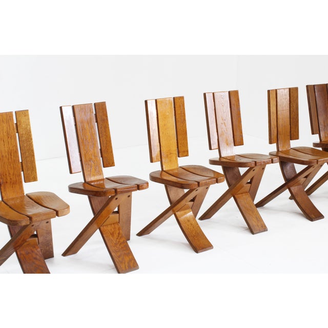 Set of 6 vintage dining chairs was crafted in the 1970s by Ebénisterie Seltz in solid oak. The design stands out for its...