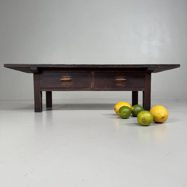 A refined Japanese low writing table from the 1920s, defined by its clean proportions and understated presence....