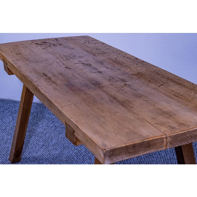 This authentic antique butcher block table is a striking piece of functional history, crafted from solid wood with a...