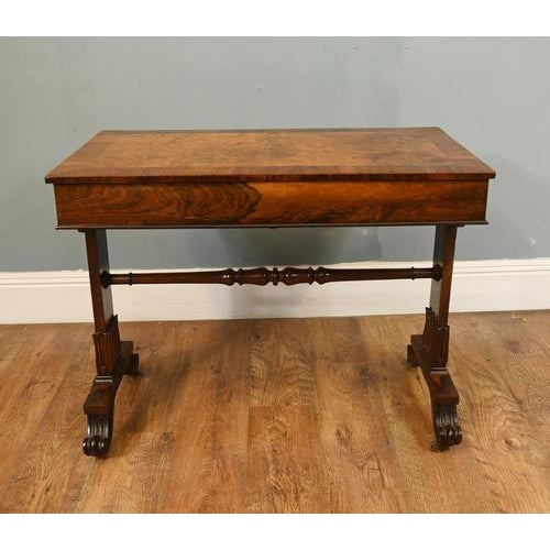 A handsome Regency walnut writing table dating to around 1820, combining elegant proportions with practical design The...