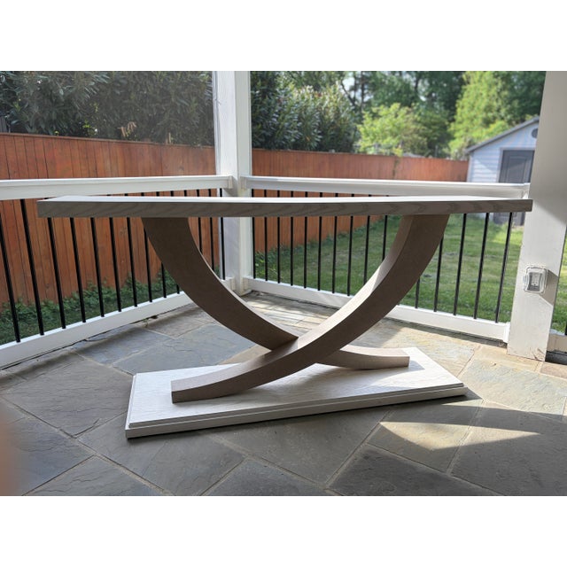 Ensemble Collection by Maitland-Smith White finish Symmetrical, sculptural console table Formed of White Oak Wood wrapped...
