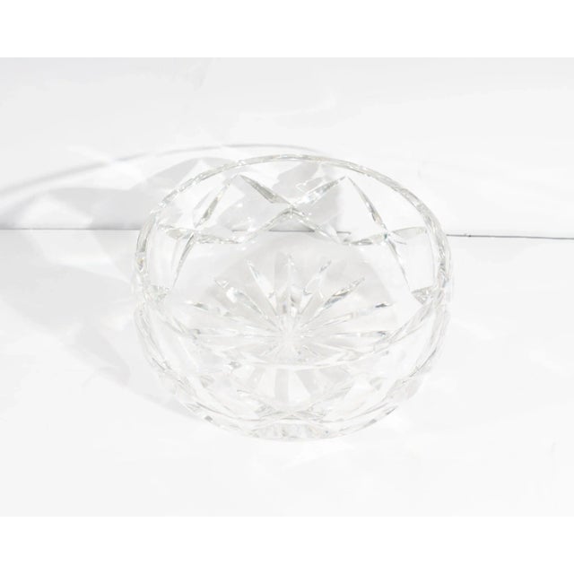 A crystal bowl produced by St. Louis France Cristal. The bowl has a crisscross design. The bowl is marked “St. Louis...