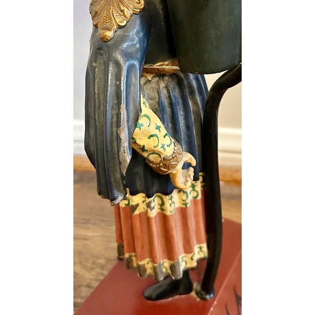 A lovely and unique pair of hand painted, tole, Chinoiserie style figural lamps. Likely dating from the late 20th C. In...