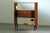 Danish bookcase in teak, produced during the 1960s. The design features two open shelves and a central cabinet with...