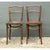 This pair of vintage bentwood dining chairs showcases the classic curved silhouette associated with early 20th-century...