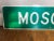 Vintage Moscow NY highway road sign. Reflective material on plywood board, four holes drilled from previous mounting.