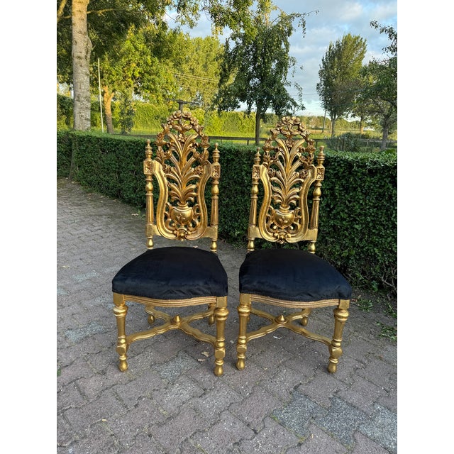 A magnificent set of six Italian Rococo Revival dining chairs, handcrafted circa 1900 and distinguished by their dramatic...