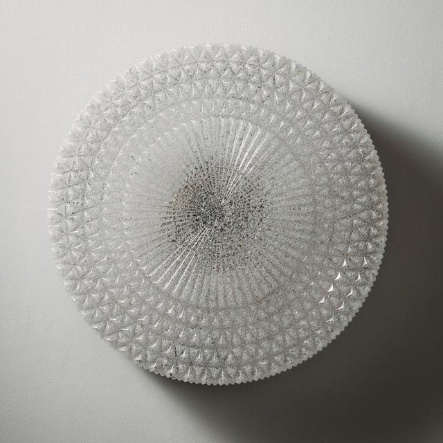 Metal and plastic wall lamp with organic shapes from the 1970s. The ceiling lamp has beautifully rounded, curved shapes...