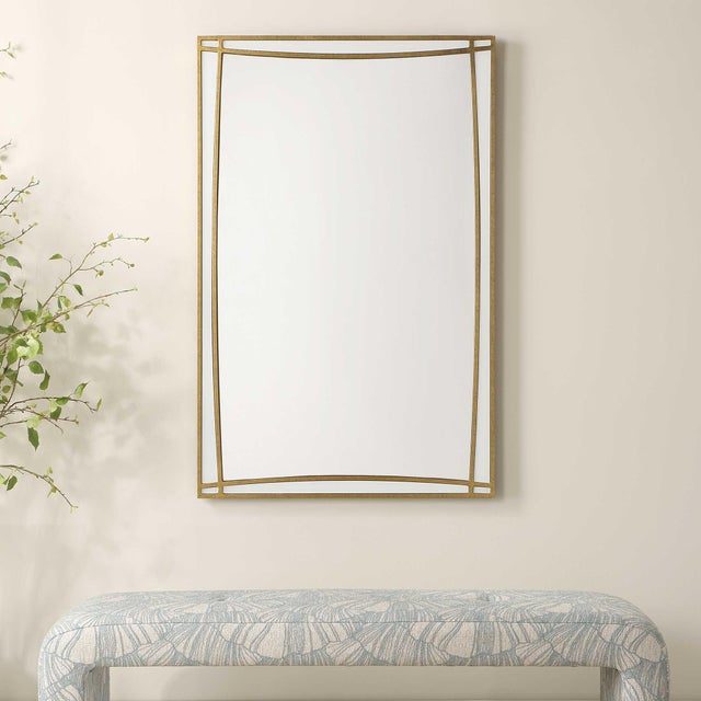 Elegantly Finished In Warm Antique Gold, This Unique Mirror Showcases Subtle Curved Inner Lines And Delicate White Glass...